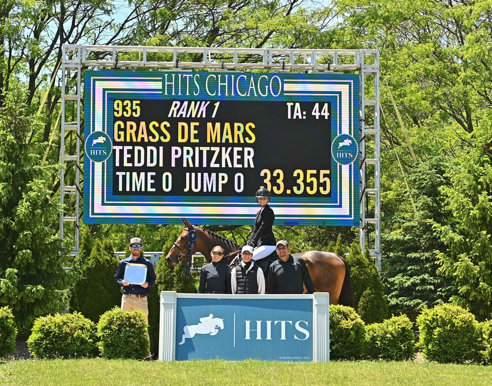Teddi Pritzker and Grass de Mars in the winner's presentation at HITS Chicago, the scoreboard reading rank one.